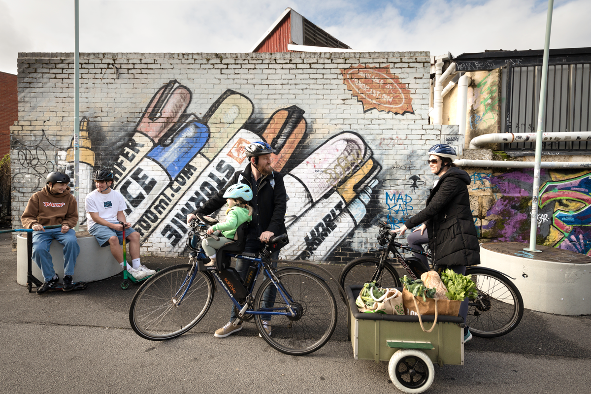 Family riding bikes with groceries